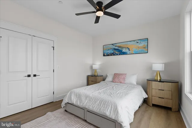 a bathroom with a sink a toilet a mirror and shower