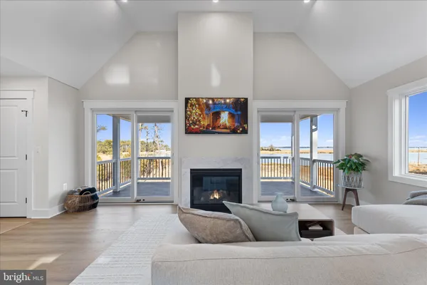 a living room with furniture chandelier and a table