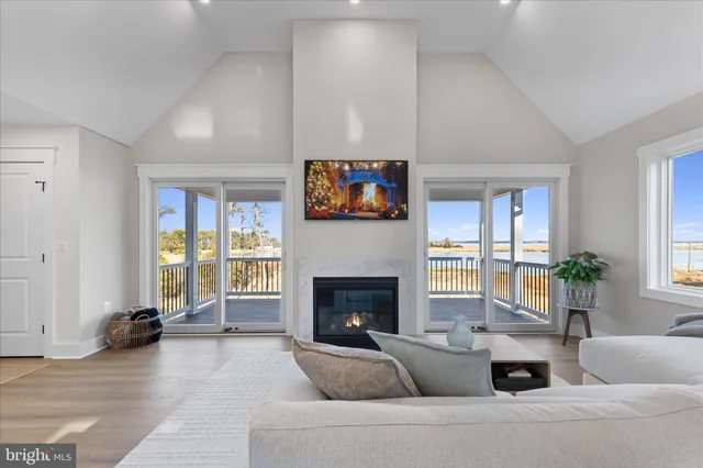 a living room with furniture chandelier and a table