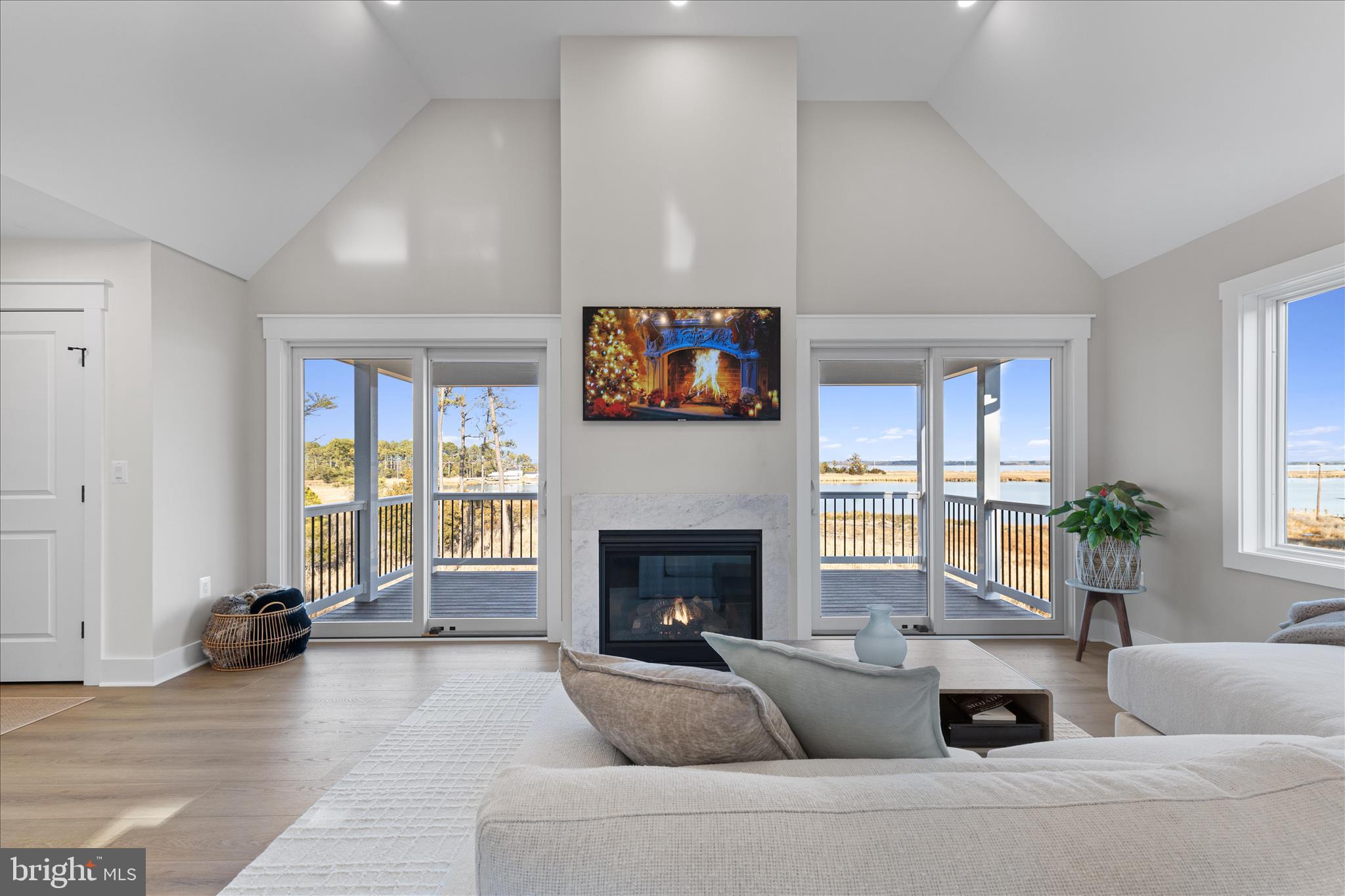 16242 Thomas Road Piney Point, MD 20674 - Photo 32 of 75 a living room with furniture a fireplace and a flat screen tv
