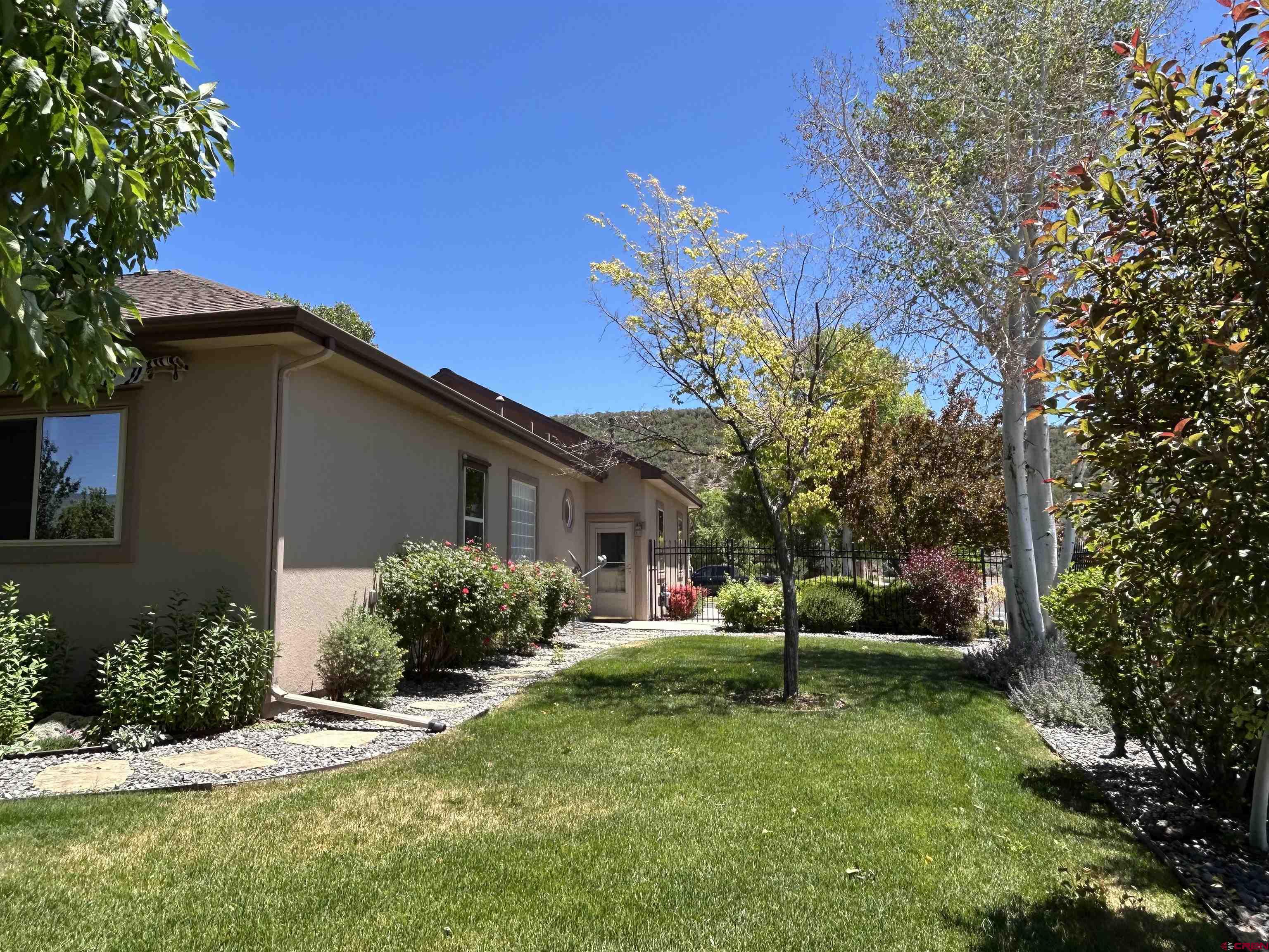 850 Southeast Pinyon Street Cedaredge, CO 81413 - Photo 34 of 45 a view of a house with a yard