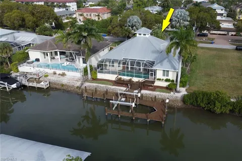 an aerial view of a house with outdoor space lake view and boat