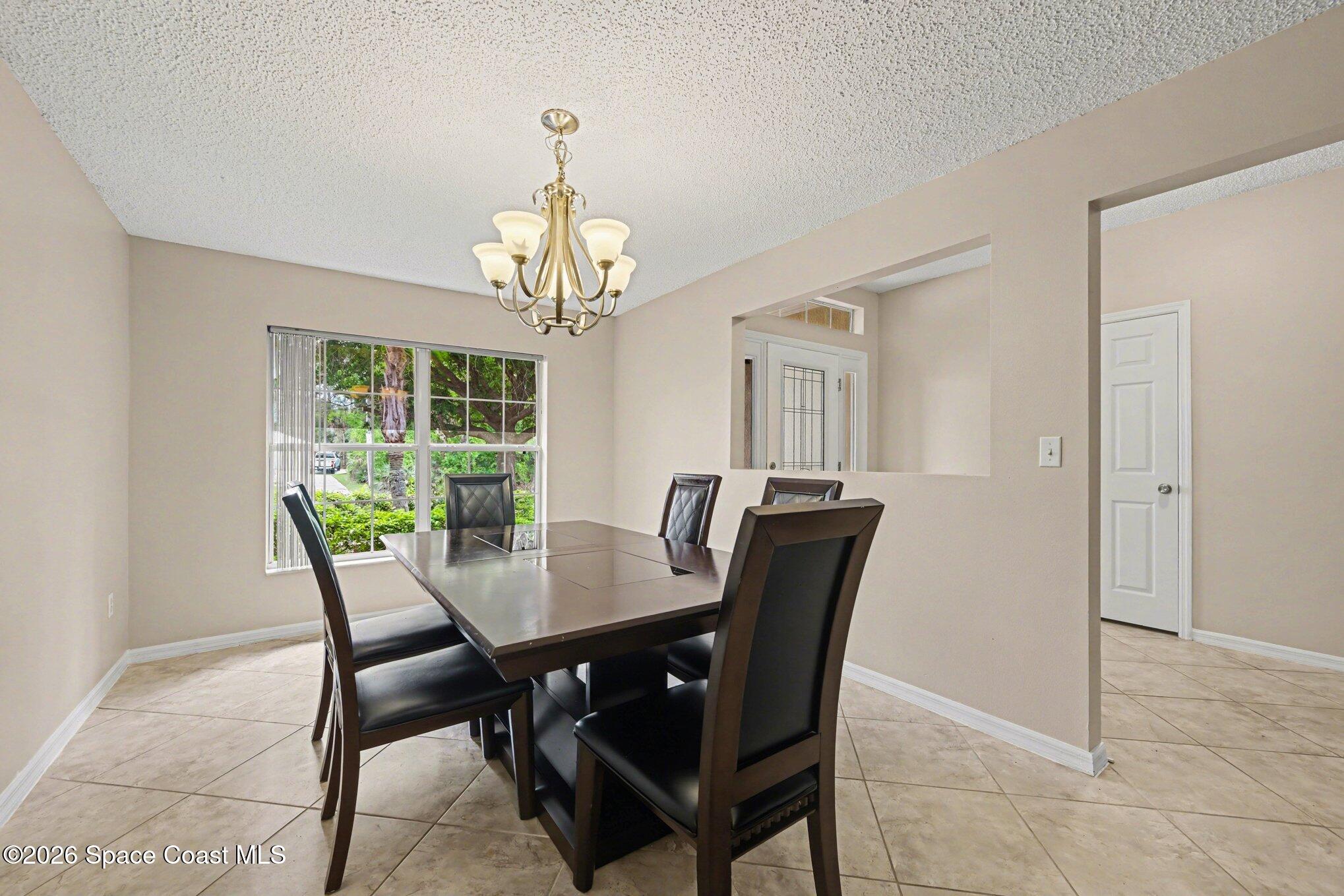 558 Barber Street Sebastian, FL 32958 - Photo 12 of 25 a view of a dining room with furniture window and outside view