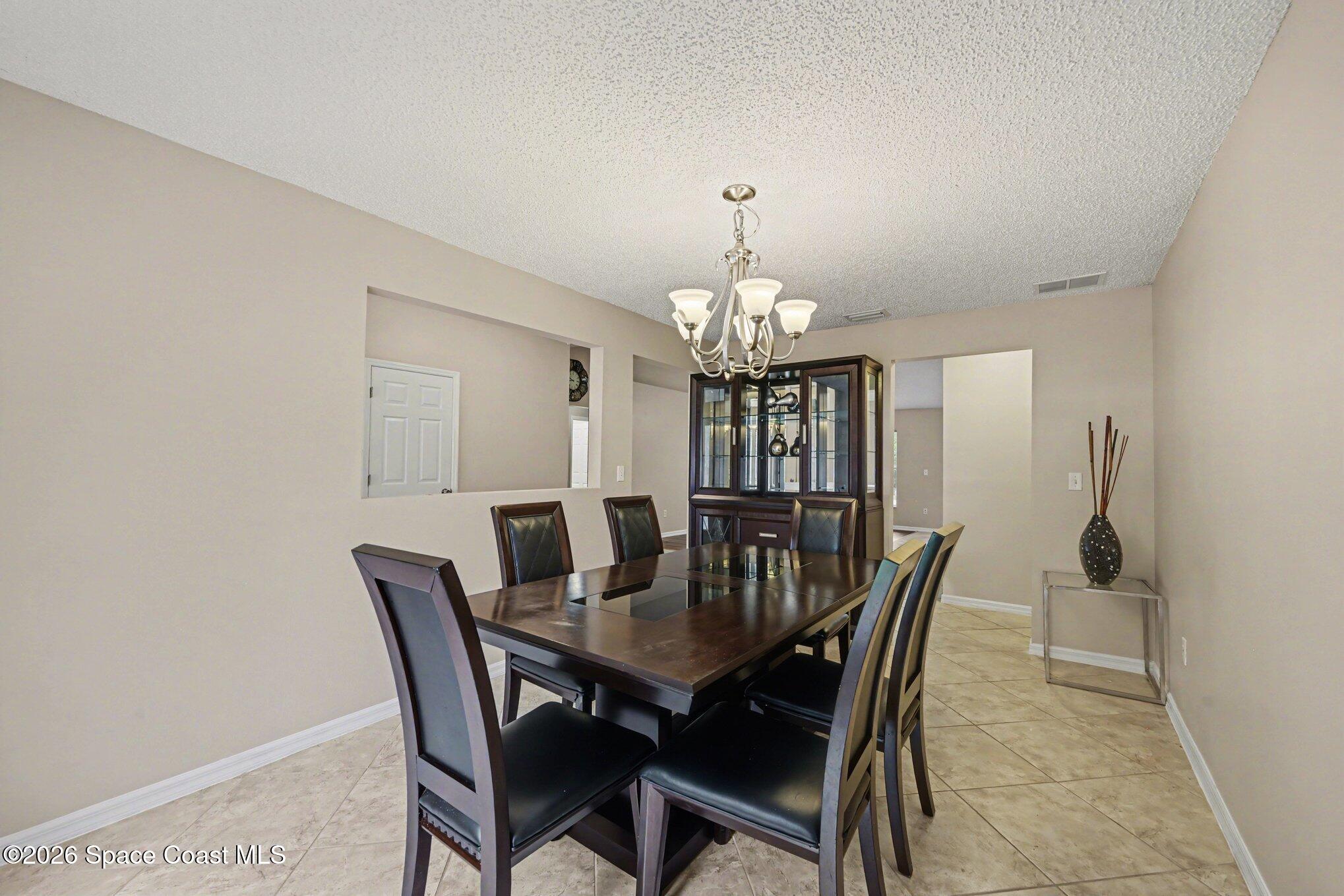 558 Barber Street Sebastian, FL 32958 - Photo 13 of 25 a view of a dining room with furniture and chandelier