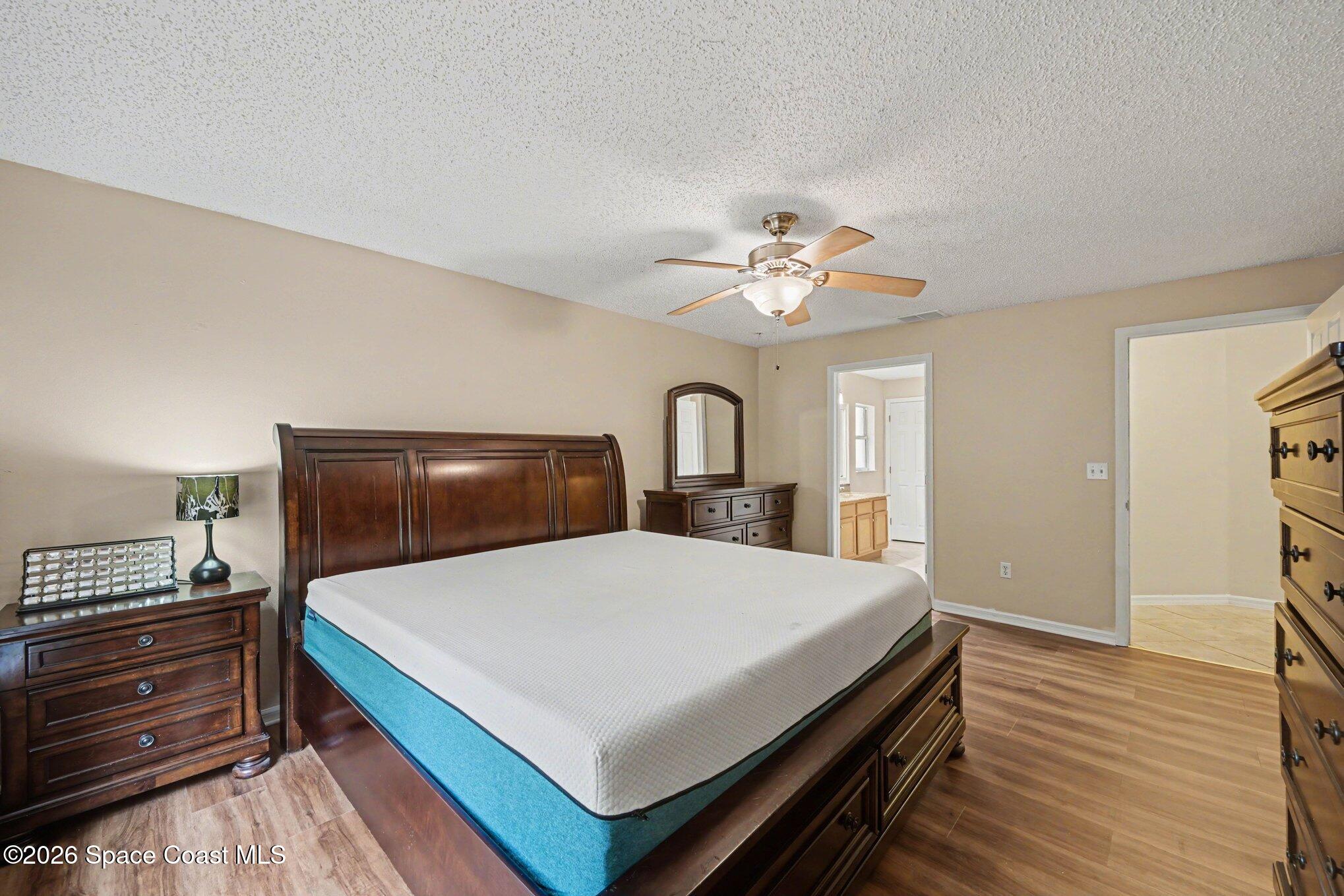 558 Barber Street Sebastian, FL 32958 - Photo 15 of 25 a bedroom with a bed and a chandelier