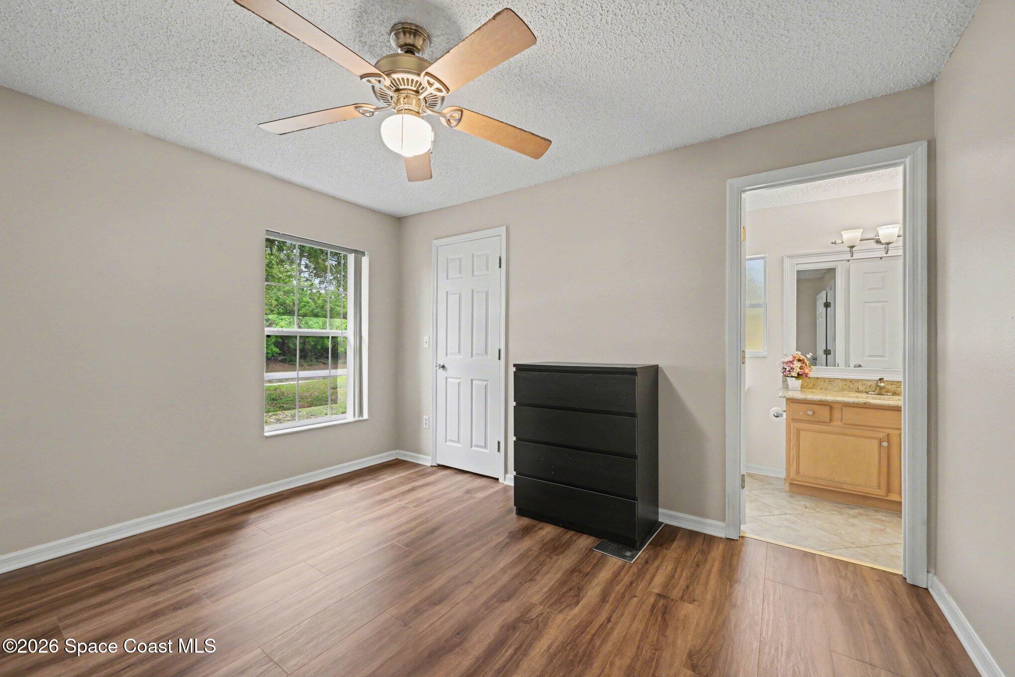 558 Barber Street Sebastian, FL 32958 - Photo 19 of 25 wooden floor in an empty room with a window
