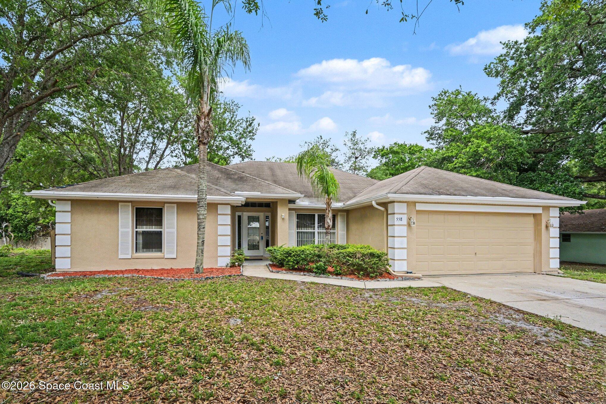 558 Barber Street Sebastian, FL 32958 - Photo 2 of 25 a front view of a house with a garden