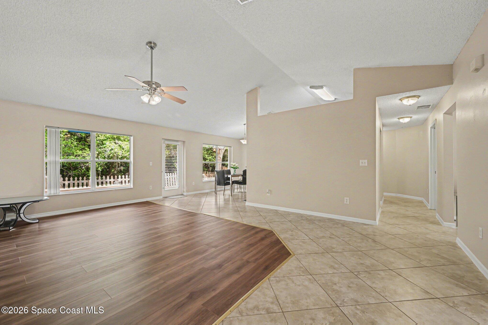 558 Barber Street Sebastian, FL 32958 - Photo 4 of 25 an empty room with wooden floor and windows