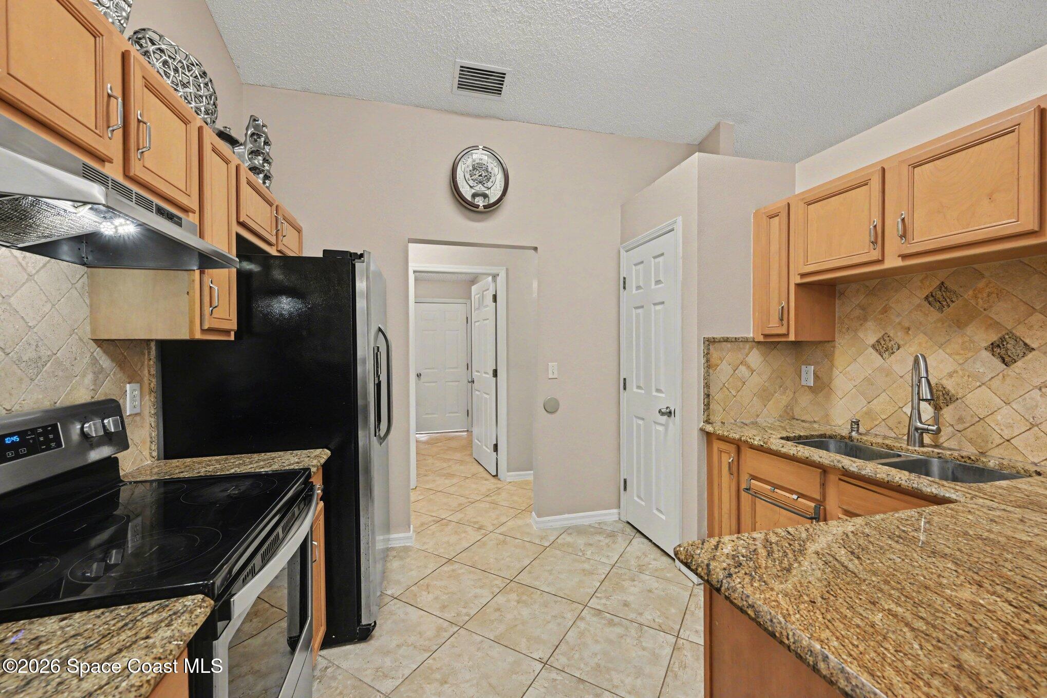 558 Barber Street Sebastian, FL 32958 - Photo 8 of 25 a kitchen with granite countertop a stove and a sink