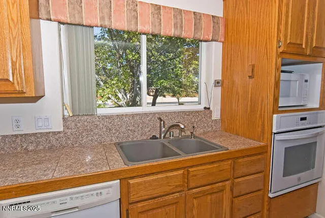 a kitchen with stainless steel appliances white cabinets and a sink