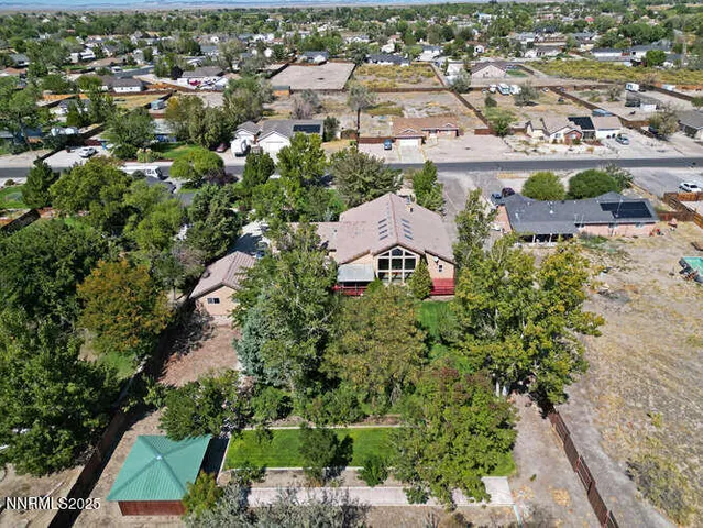 an aerial view of a house with a yard