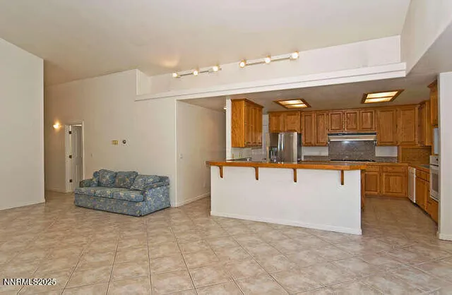 a kitchen with stainless steel appliances granite countertop a stove and cabinets