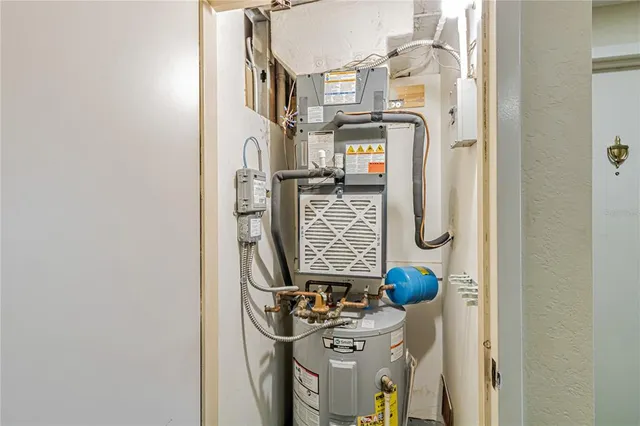 a living room with furniture a chandelier and a dining table
