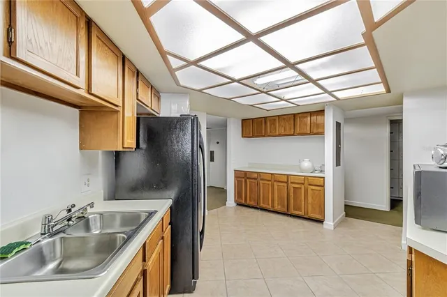 a kitchen with a refrigerator and a sink
