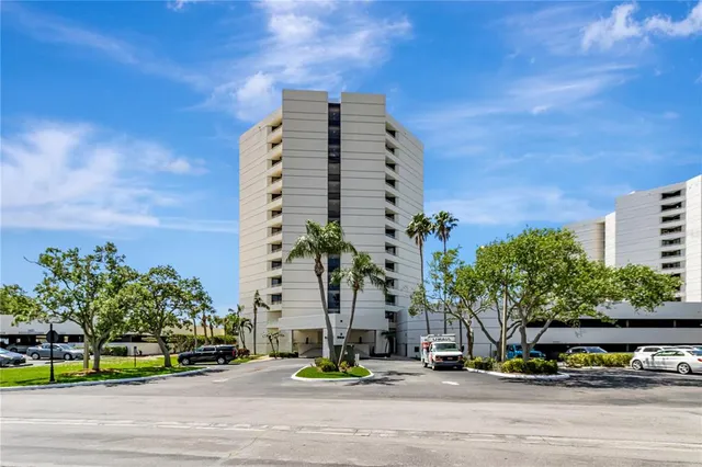 a view of a tall building next to a road