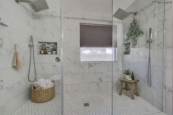 a bathroom with a toilet and a shower