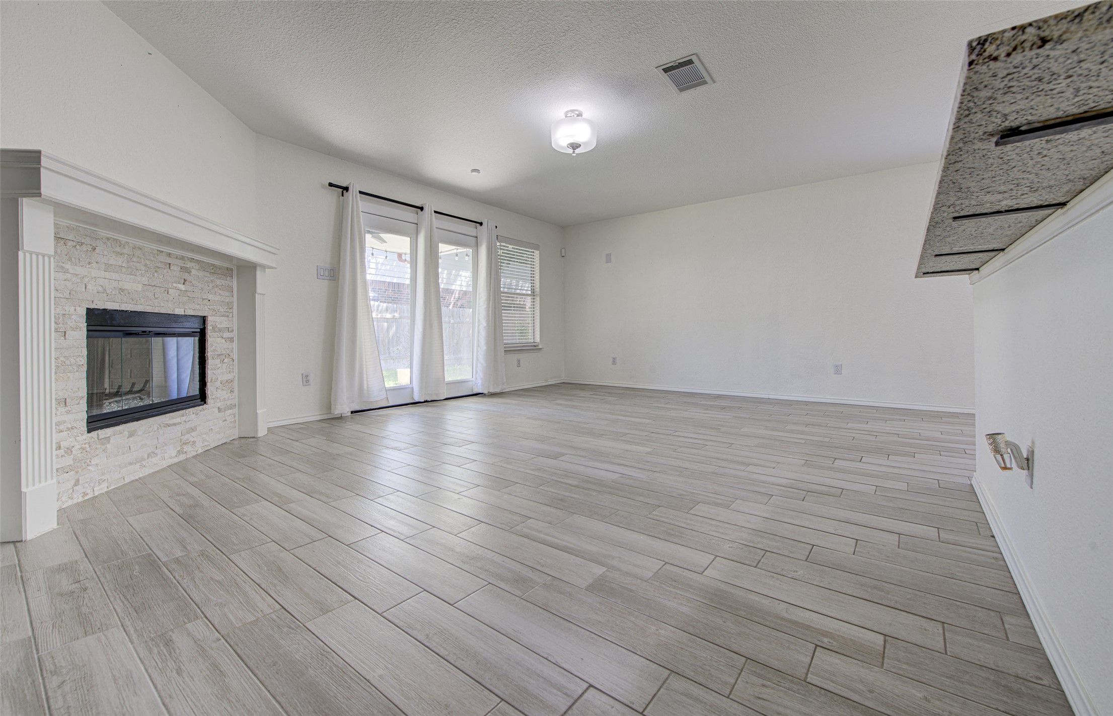 5908 Krinan Court Austin, TX 78754 - Photo 11 of 31 wooden floor in an empty room with a fireplace
