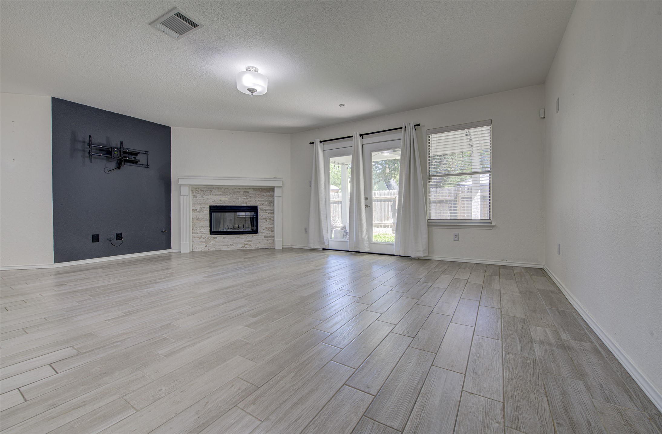 5908 Krinan Court Austin, TX 78754 - Photo 12 of 31 wooden floor fireplace and windows in an empty room