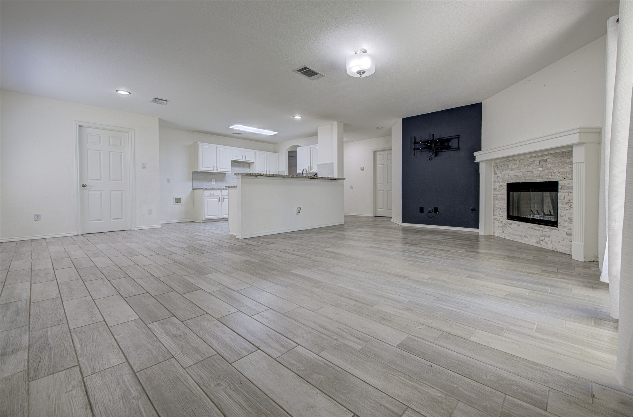 5908 Krinan Court Austin, TX 78754 - Photo 13 of 31 a view of a kitchen with wooden floor and a fireplace