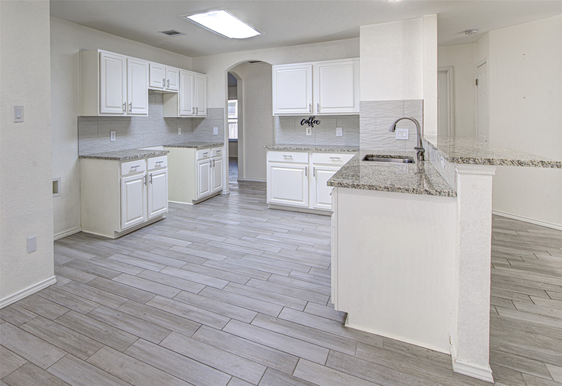 5908 Krinan Court Austin, TX 78754 - Photo 15 of 31 a kitchen with granite countertop a sink and cabinets with wooden floors