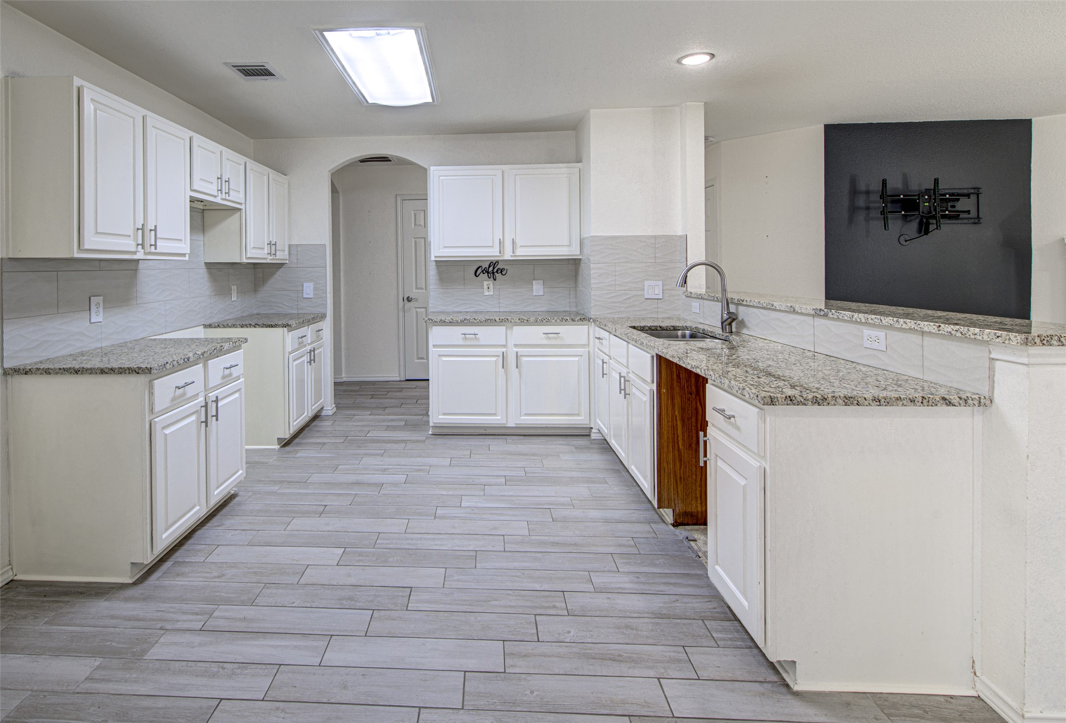 5908 Krinan Court Austin, TX 78754 - Photo 16 of 31 a large kitchen with granite countertop a sink and cabinets
