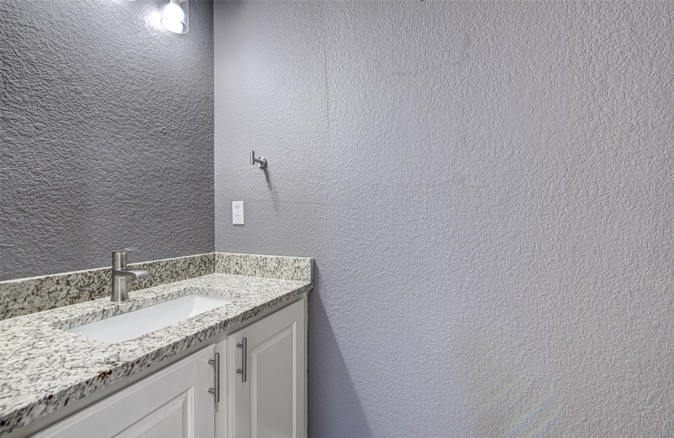 5908 Krinan Court Austin, TX 78754 - Photo 18 of 31 a bathroom with a granite countertop sink and a mirror
