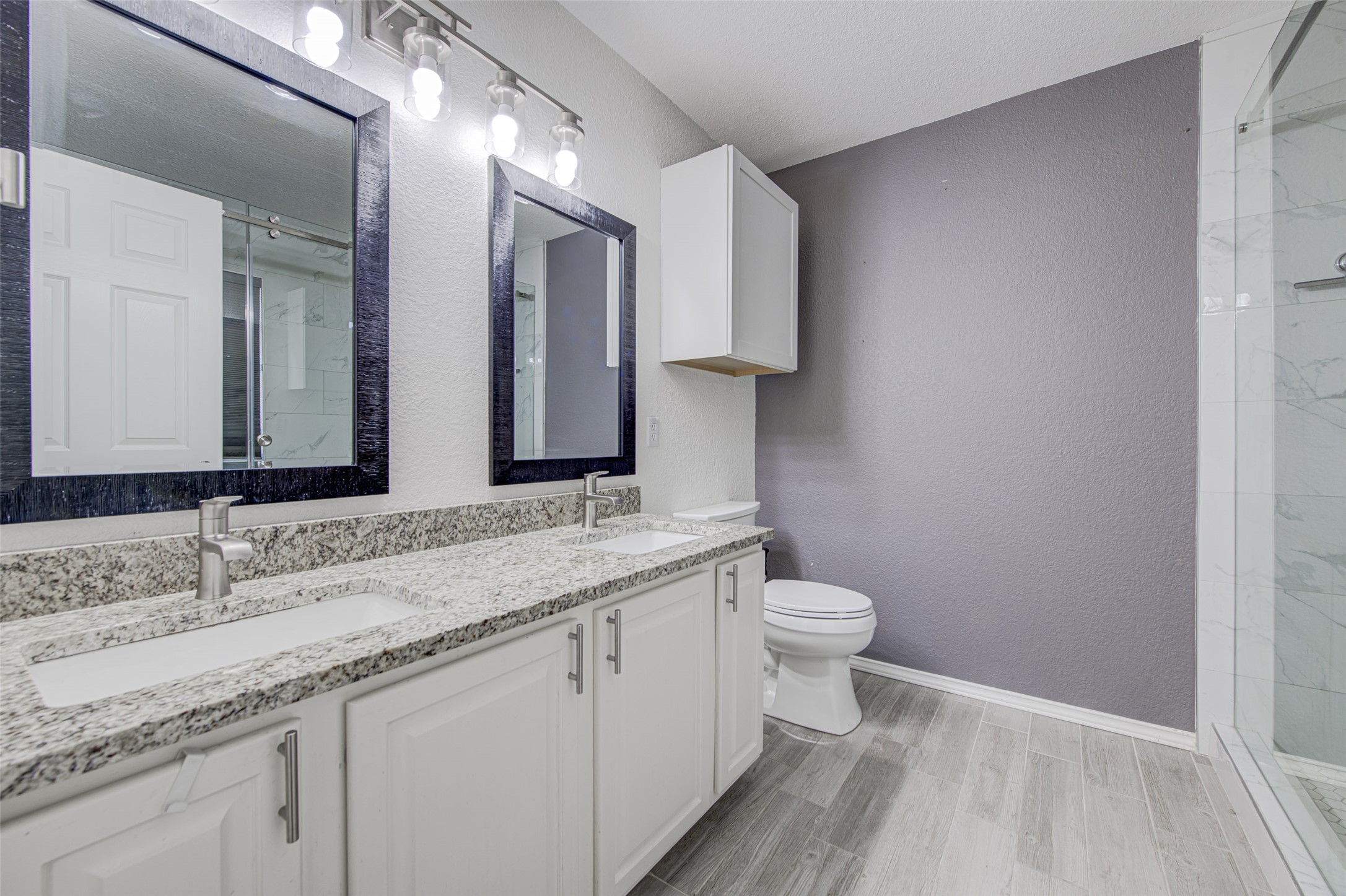 5908 Krinan Court Austin, TX 78754 - Photo 21 of 31 a bathroom with a granite countertop sink a toilet and a mirror