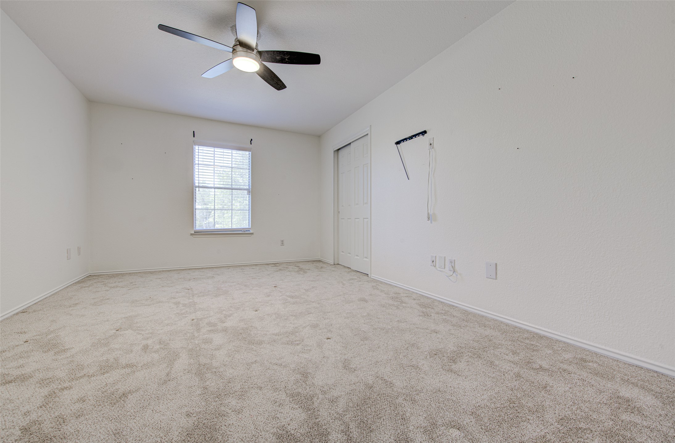 5908 Krinan Court Austin, TX 78754 - Photo 26 of 31 an empty room with windows and chandelier fan