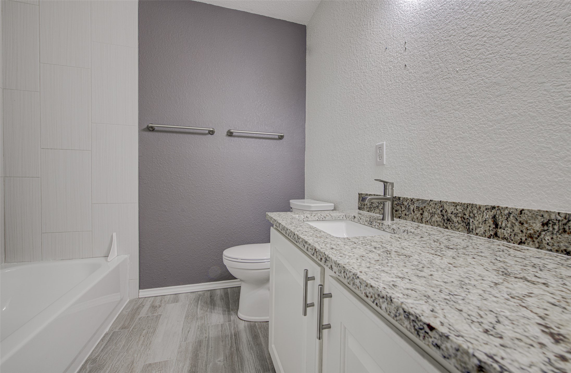 5908 Krinan Court Austin, TX 78754 - Photo 29 of 31 a bathroom with a granite countertop sink a toilet and bathtub