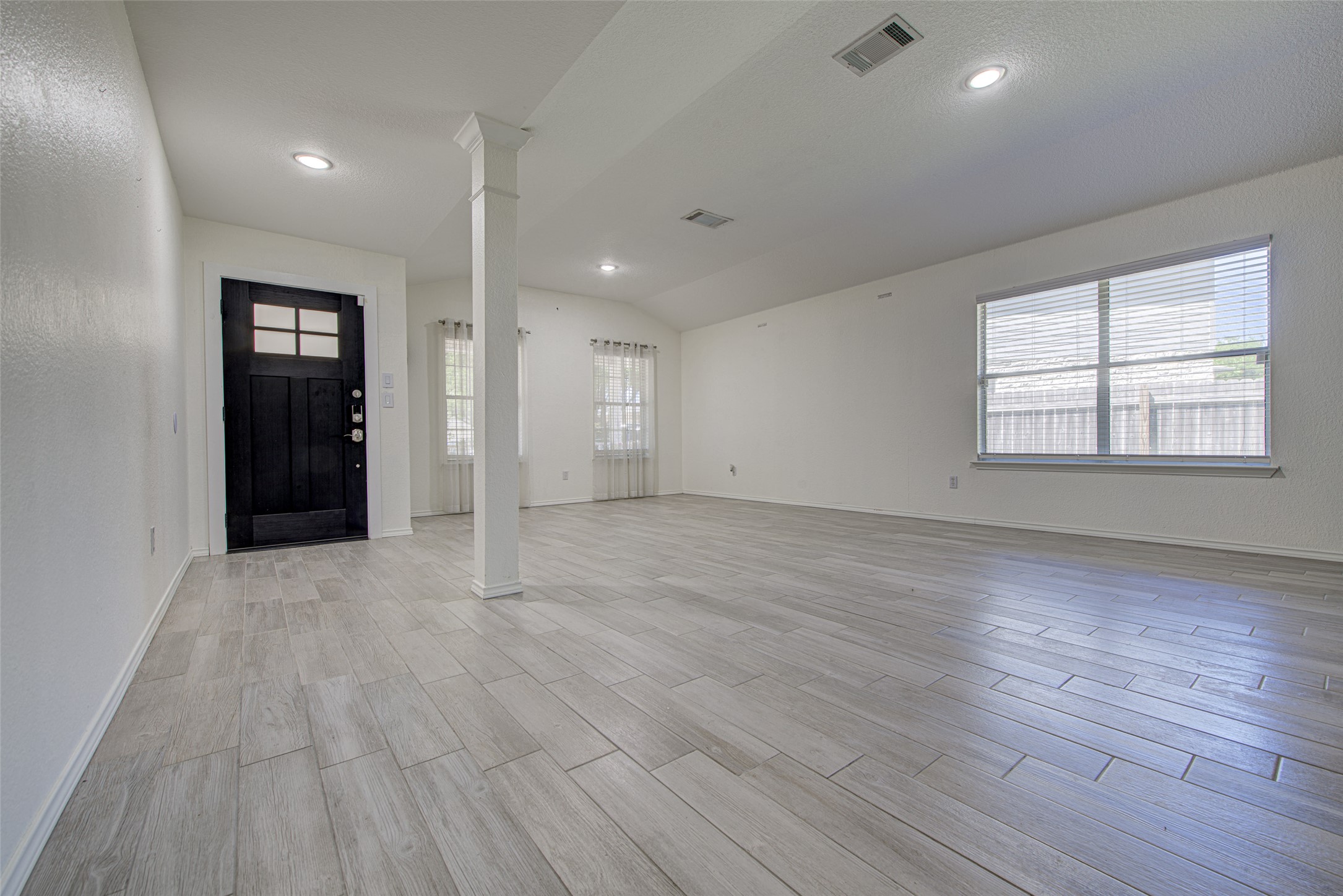 5908 Krinan Court Austin, TX 78754 - Photo 8 of 31 an empty room with wooden floor and windows