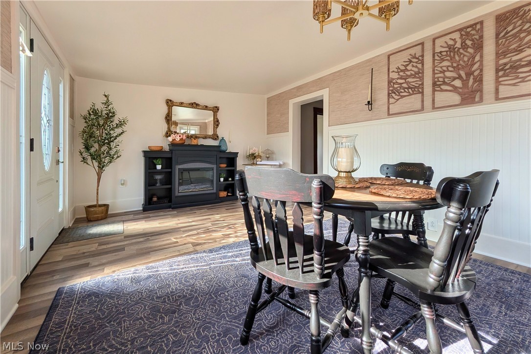 12972 Gilmore Road Southeast Port Washington, OH 43837 - Photo 4 of 50 Dining space featuring wood finished floors and a wainscoted wall
