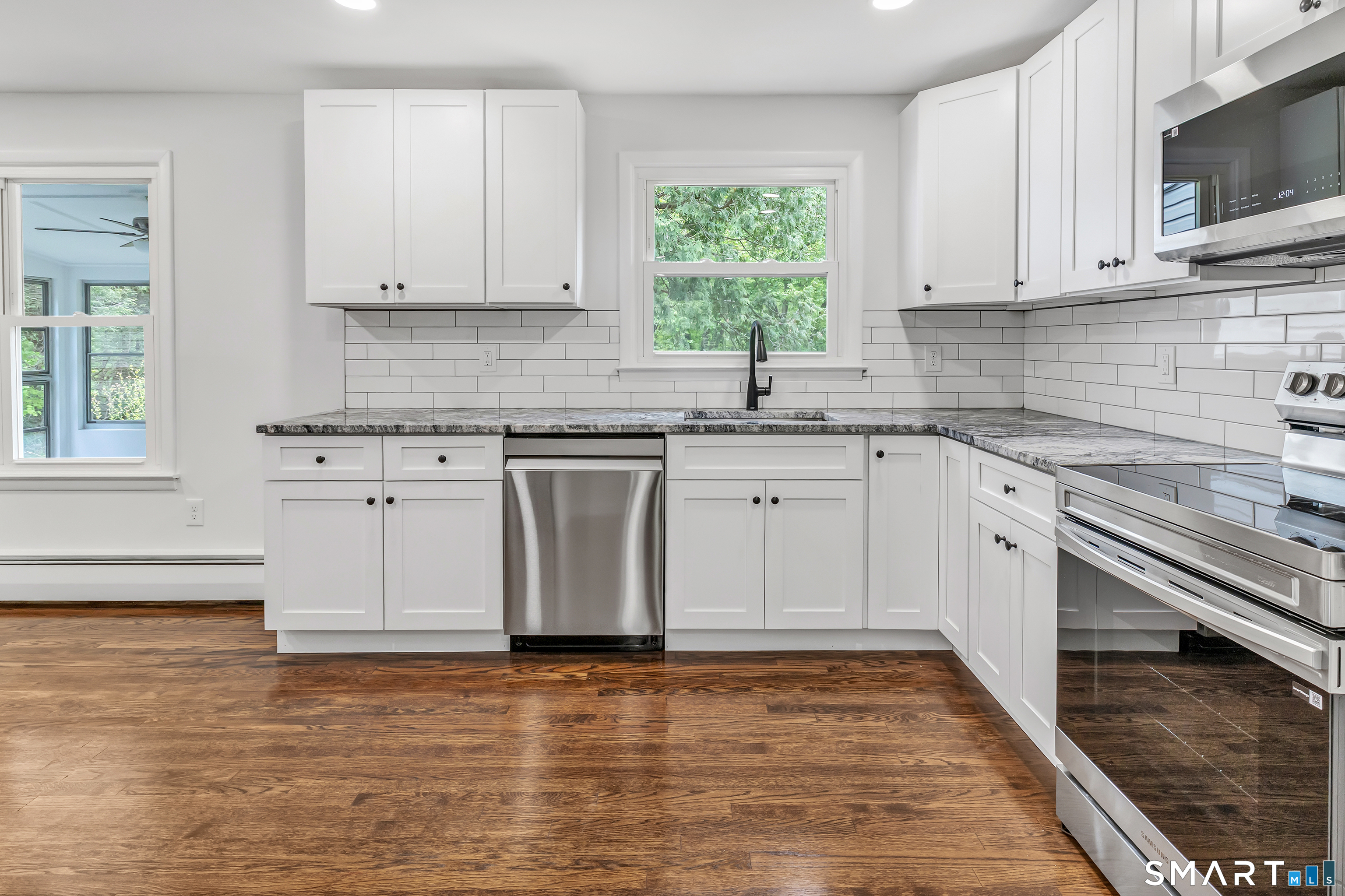 7 Longview Road Newtown, CT 06482 - Photo 13 of 40 a kitchen with stainless steel appliances granite countertop a stove a sink and a microwave