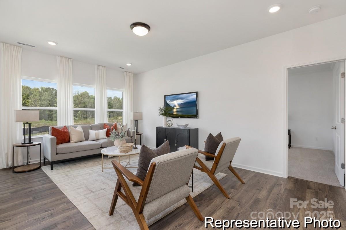 104 Soft Breeze Bend, Unit 160B Locust, NC 28097 - Photo 11 of 22 a living room with furniture and a flat screen tv