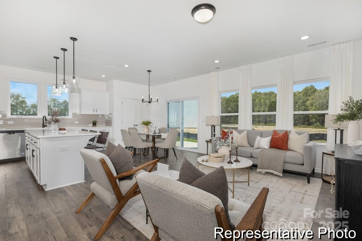 104 Soft Breeze Bend, Unit 160B Locust, NC 28097 - Photo 12 of 22 a living room with lots of furniture and a large window