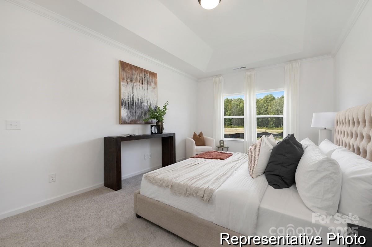 104 Soft Breeze Bend, Unit 160B Locust, NC 28097 - Photo 15 of 22 a bedroom with a bed and a window