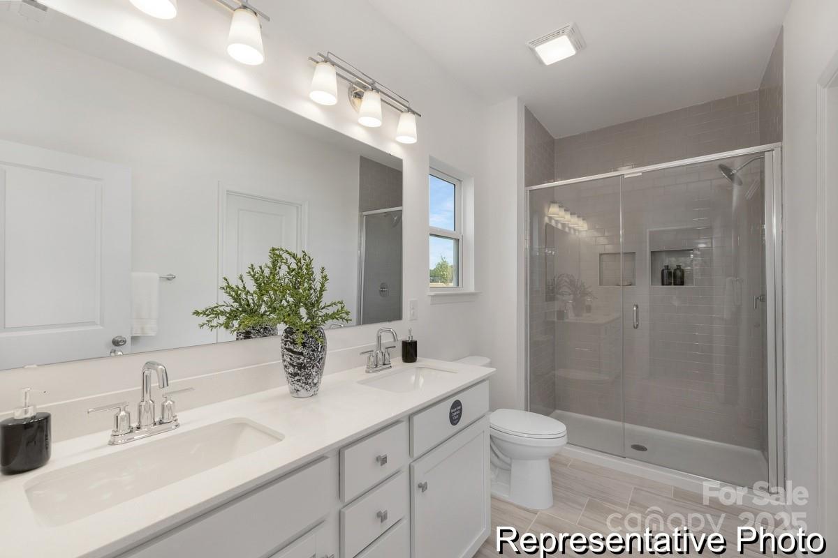 104 Soft Breeze Bend, Unit 160B Locust, NC 28097 - Photo 17 of 22 a bathroom with a sink a toilet and shower