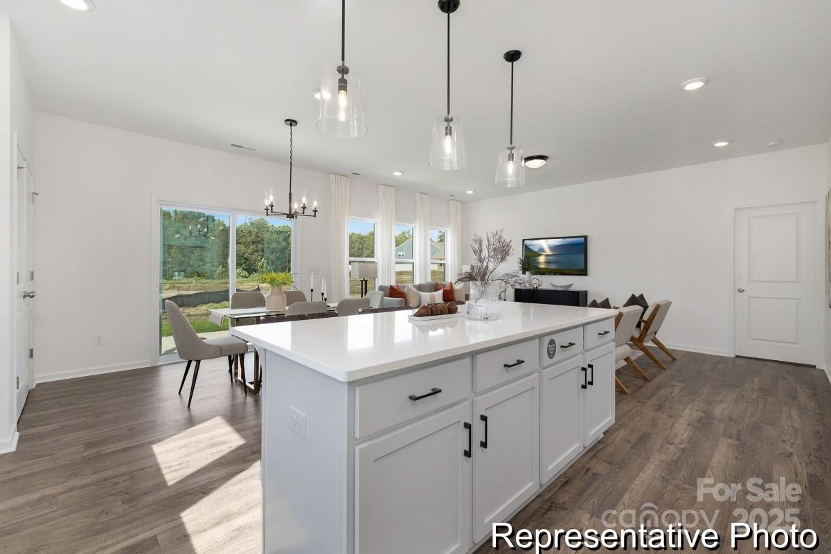 104 Soft Breeze Bend, Unit 160B Locust, NC 28097 - Photo 5 of 22 a large kitchen with kitchen island a flat screen tv a island and stainless steel appliances