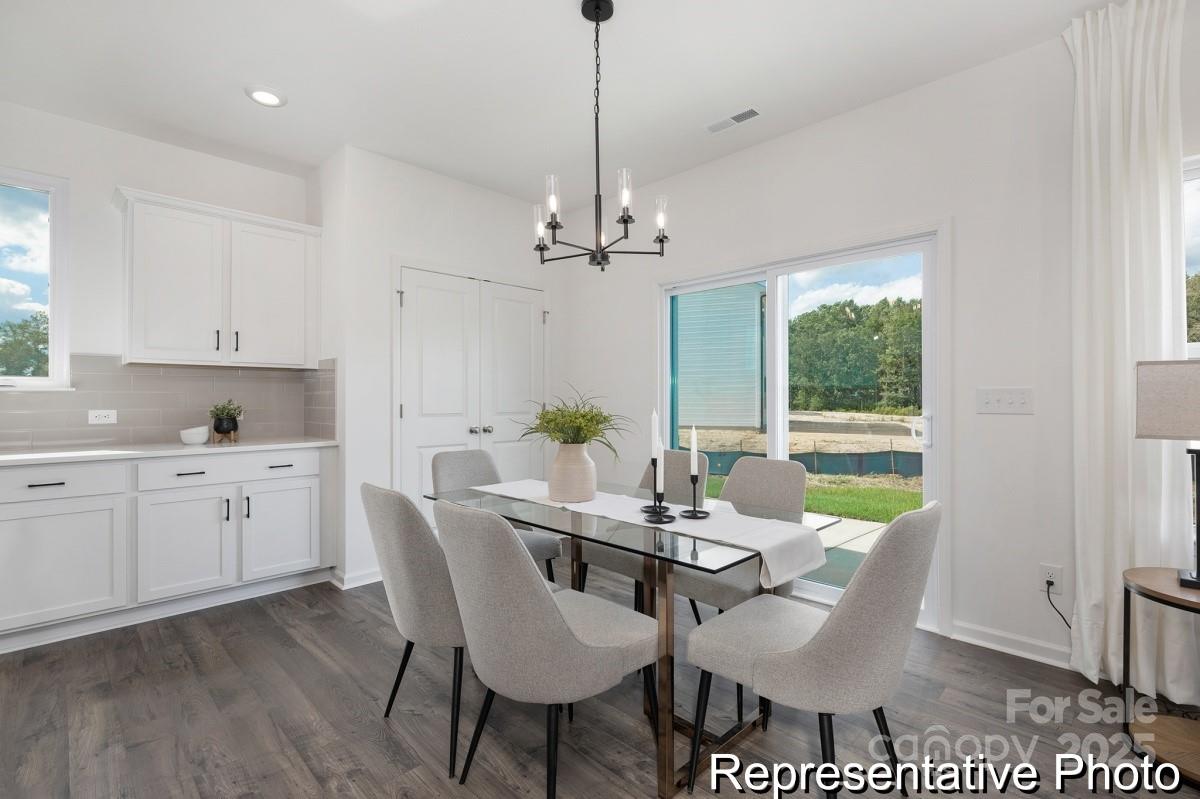 104 Soft Breeze Bend, Unit 160B Locust, NC 28097 - Photo 8 of 22 a view of a dining room with furniture window and wooden floor