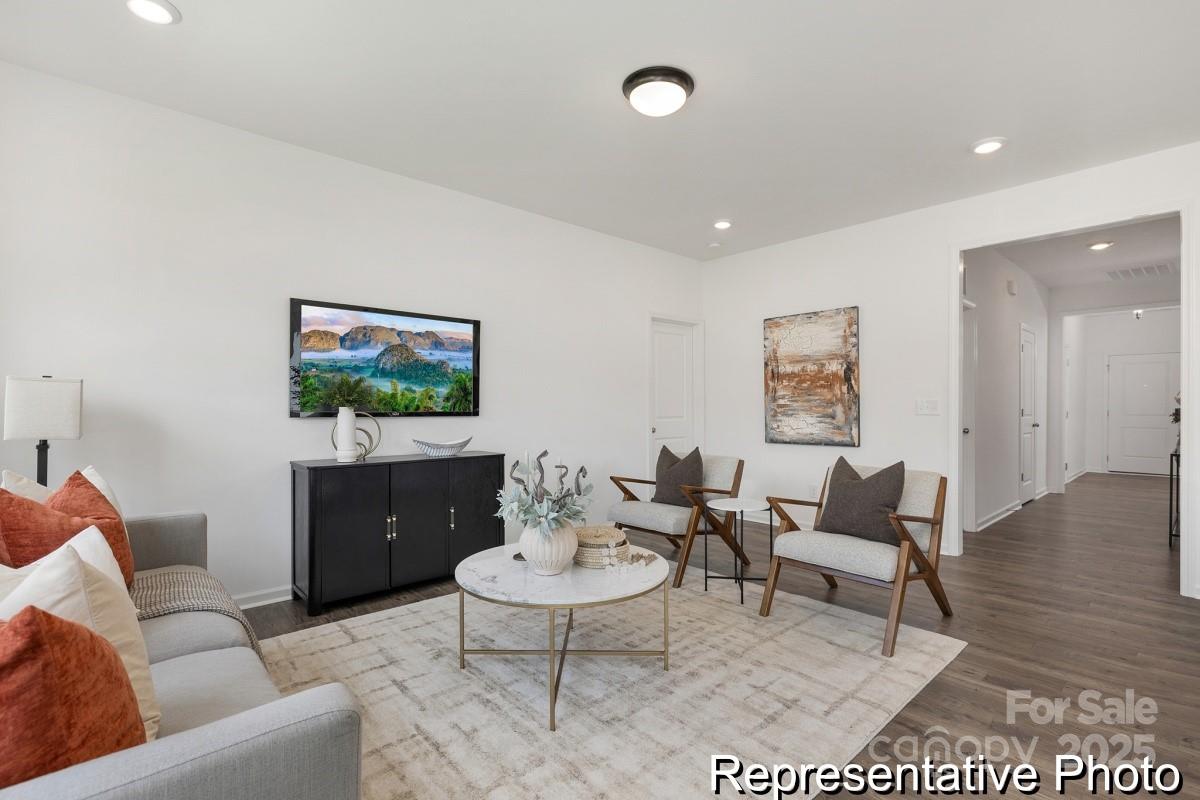 104 Soft Breeze Bend, Unit 160B Locust, NC 28097 - Photo 9 of 22 a living room with furniture a rug a lamp and a flat screen tv