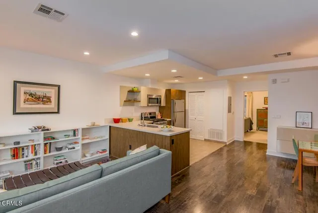 a living room with furniture and kitchen view