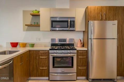 a kitchen with a stove and a refrigerator