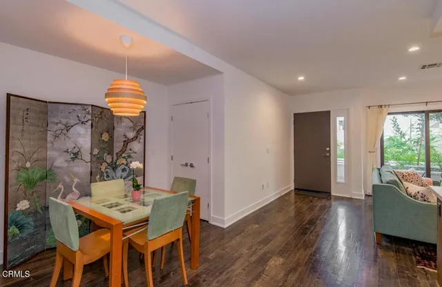 a dining room with furniture and wooden floor