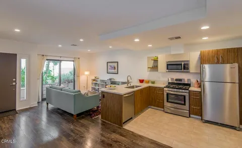 a kitchen with stove and refrigerator