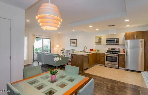 a kitchen with sink refrigerator and microwave