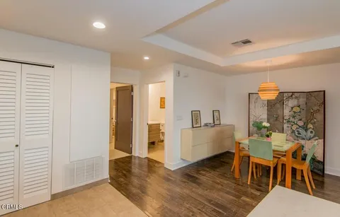 a living room with furniture and a dining table