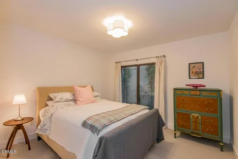 a bedroom with a bed and a lamp