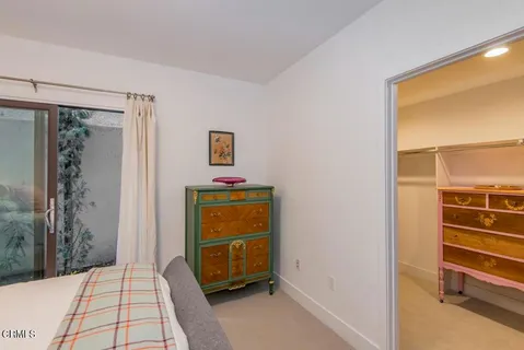 a bedroom with a bed and a cabinets