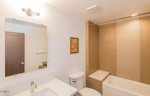 a bathroom with a toilet a sink and shower