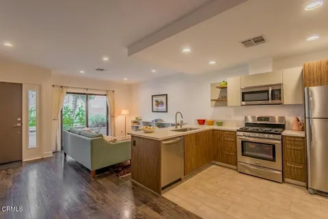 a kitchen with a sink appliances and cabinets
