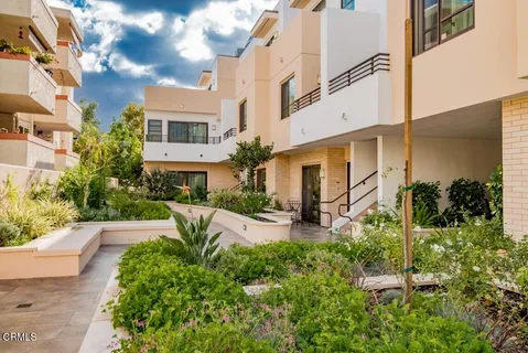 a view of a patio with plants and a table and chairs